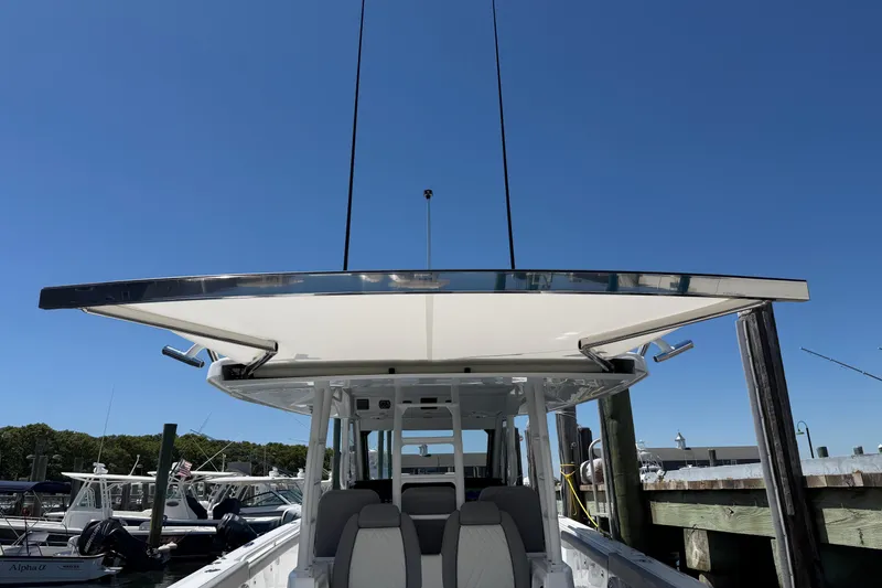 Slide: The Image of 2026 Everglades 395 Center Console boat docked under clear blue sky. - 36