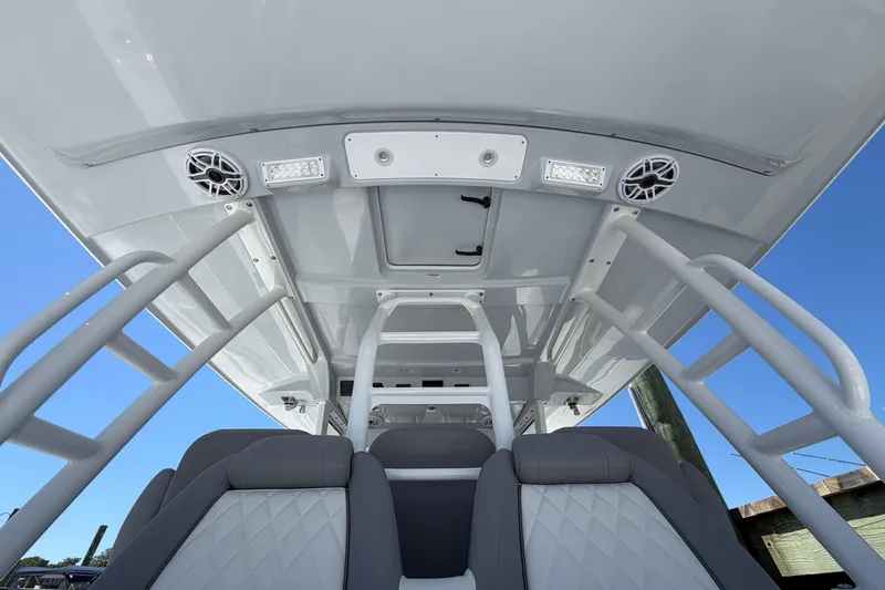 Slide: The Image of 2026 Everglades 395 Center Console boat interior with speakers and seating. - 40