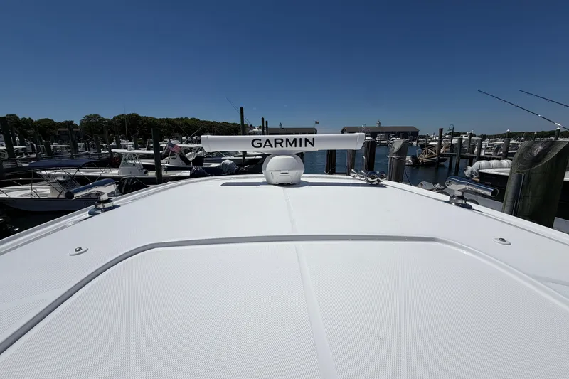 Slide: The Image of 2026 Everglades 395 Center Console boat with Garmin equipment at a marina. - 42
