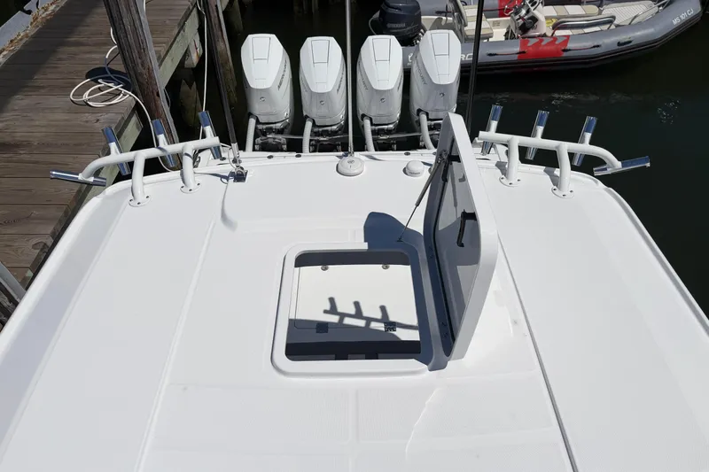 Slide: The Image of 2026 Everglades 395 Center Console boat with open hatch and multiple outboard engines. - 43
