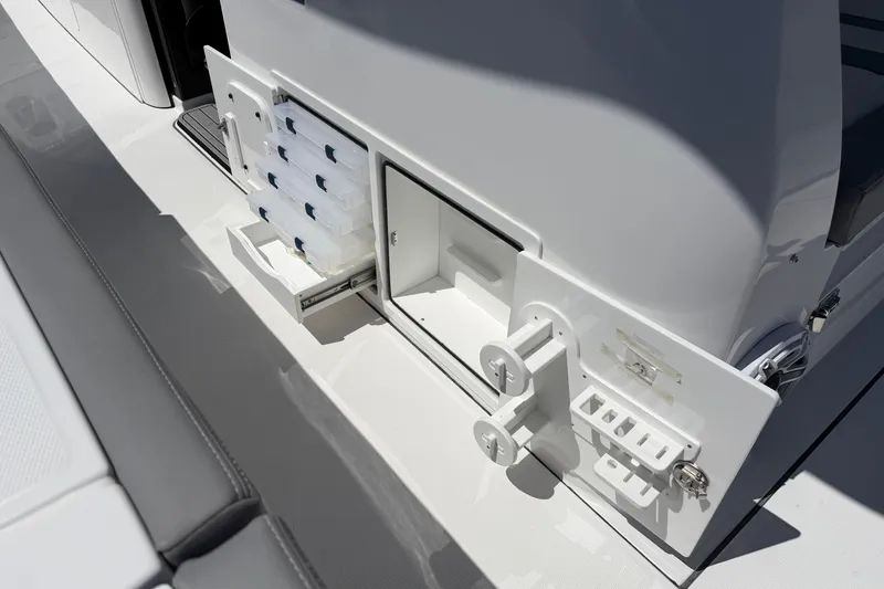 Slide: The Image of 2026 Everglades 395 Center Console boat storage compartments and tackle station. - 45