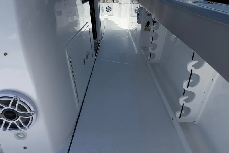Slide: The Image of 2026 Everglades 395 Center Console boat interior with rod holders and speaker system. - 46