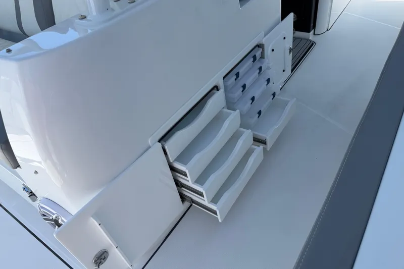 Slide: The Image of Storage compartments on a 2026 Everglades 395 Center Console boat, featuring organized drawers. - 47