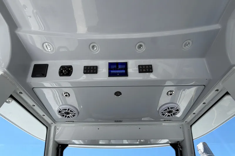 Slide: The Image of Interior view of 2026 Everglades 395 Center Console boat's control panel and speakers. - 58