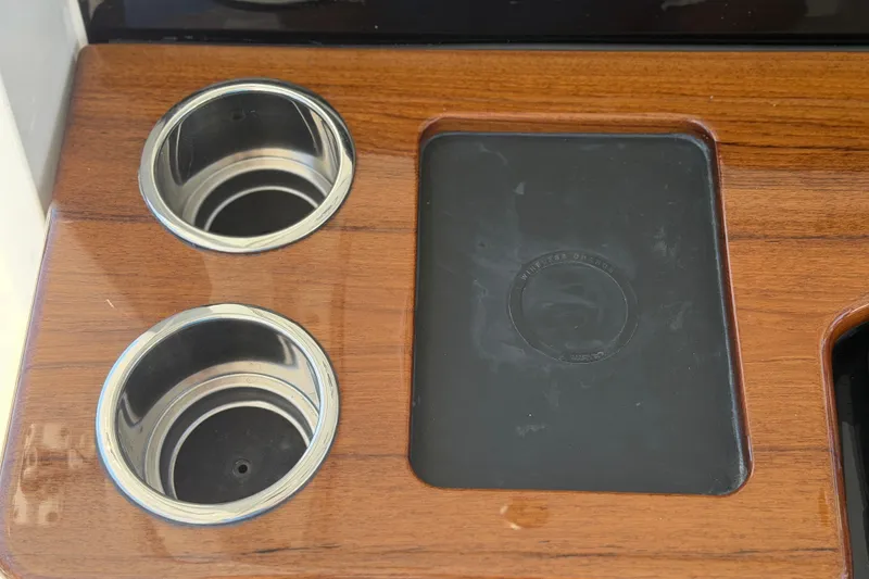 Slide: The Image of Cup holders and wireless charging pad on 2026 Everglades 395 Center Console boat. - 60