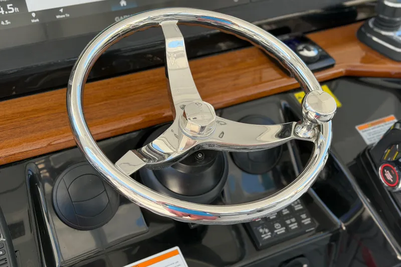 Slide: The Image of Steering wheel of 2026 Everglades 395 Center Console boat, featuring sleek chrome design. - 61