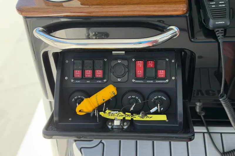 Slide: The Image of Control panel of 2026 Everglades 395 Center Console boat with switches and keys. - 65