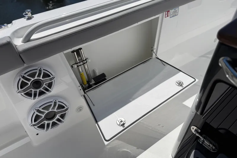 Slide: The Image of Open storage compartment on 2026 Everglades 395 Center Console boat with speakers visible. - 74
