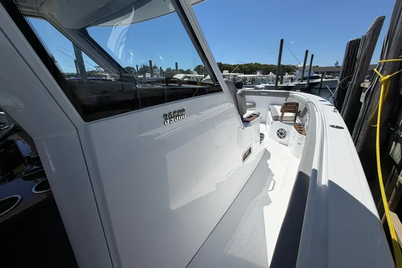 Slide: The Image of 2026 Everglades 395 Center Console boat docked, showcasing sleek design and spacious deck. - 76