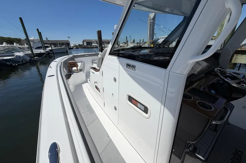 Slide: The Image of 2026 Everglades 395 Center Console boat docked at marina, showcasing sleek design. - 77