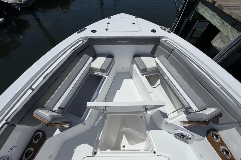 Slide: The Image of 2026 Everglades 395 Center Console boat interior with cushioned seating and storage compartments. - 81
