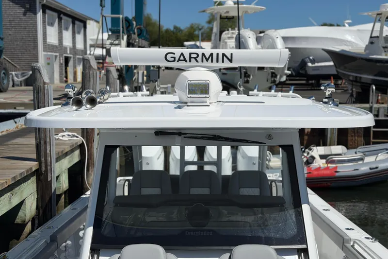 Slide: The Image of 2026 Everglades 395 Center Console boat docked, featuring Garmin equipment on the roof. - 92