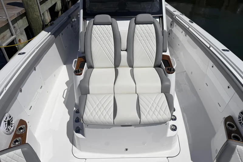 Slide: The Image of Luxury seating on 2026 Everglades 395 Center Console boat, featuring elegant white and gray upholstery. - 94