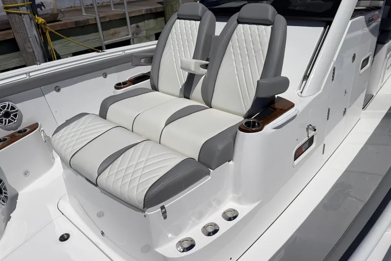 Slide: The Image of Luxurious seating on 2026 Everglades 395 Center Console boat, featuring elegant white and gray upholstery. - 95