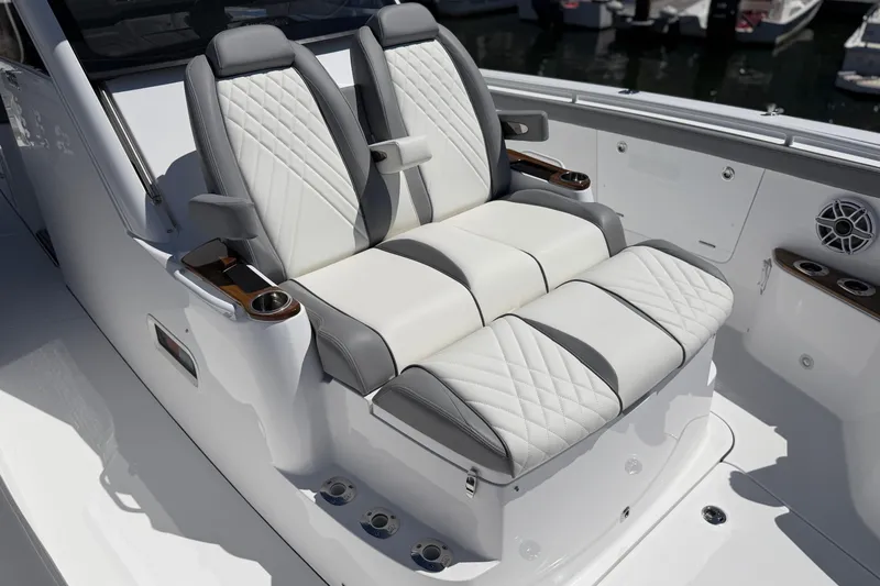Slide: The Image of Luxury seating on 2026 Everglades 395 Center Console boat, featuring elegant white and gray upholstery. - 96