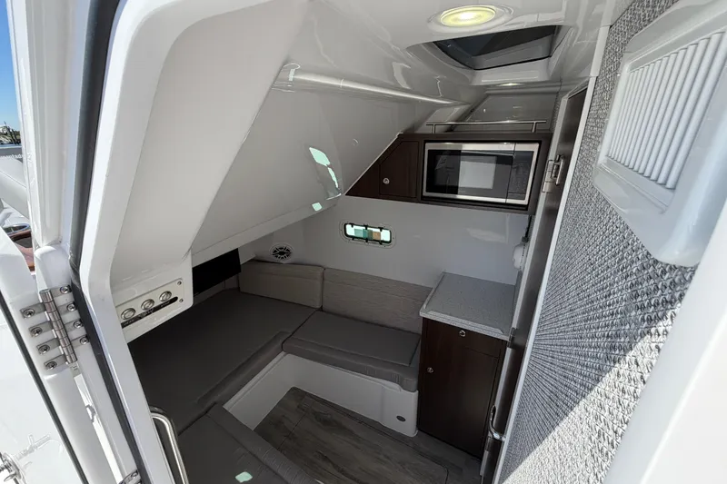 Slide: The Image of Interior cabin of 2026 Everglades 395 Center Console boat with seating and kitchenette. - 98