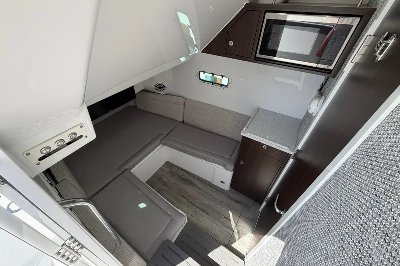 Slide: The Image of Interior cabin of 2026 Everglades 395 Center Console with seating and kitchenette. - 99