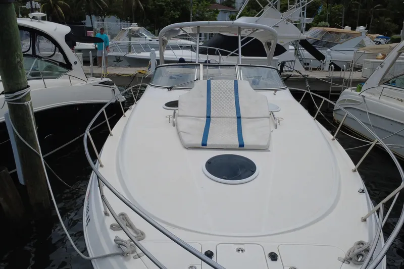 Slide: The Image of 2006 Regal Commodore 3560 yacht docked at marina, featuring spacious deck and sunbed. - 11