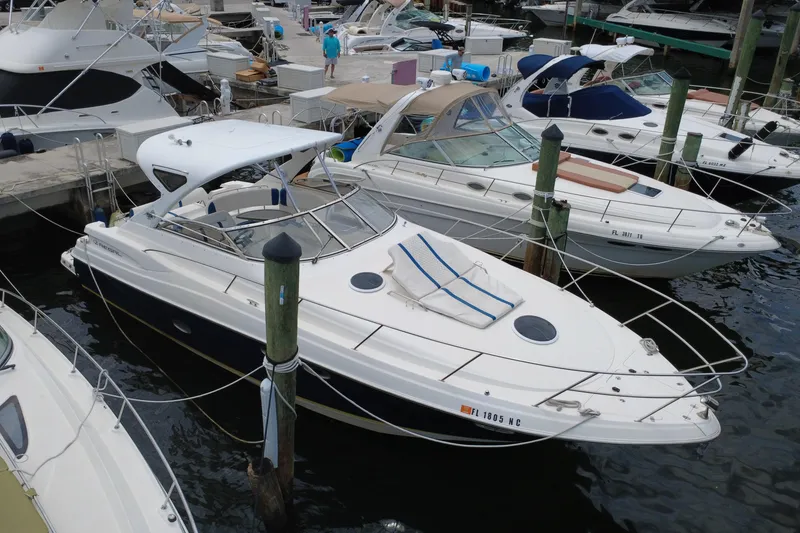 Slide: The Image of 2006 Regal Commodore 3560 yacht docked at marina, surrounded by other boats. - 7