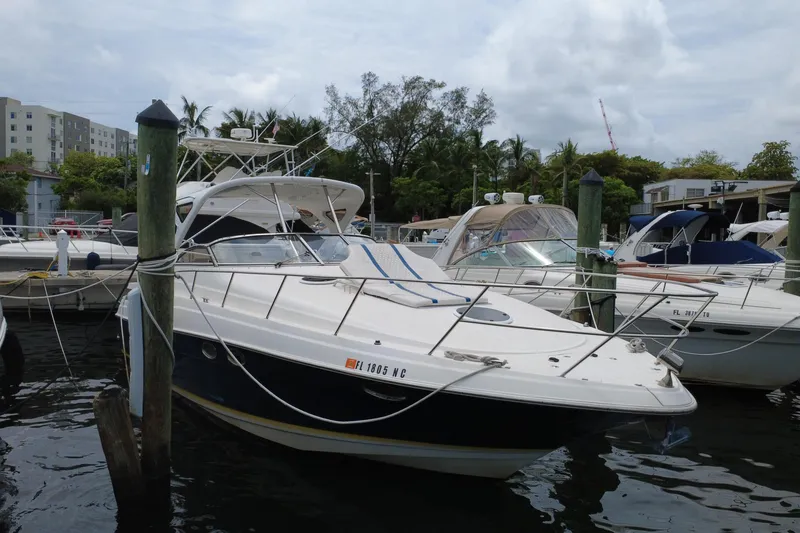 Slide: The Image of 2006 Regal Commodore 3560 yacht docked at marina, surrounded by other boats. - 9