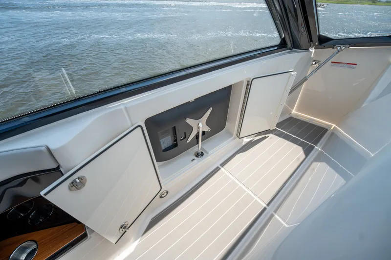 Slide: The Image of The image shows the cockpit of a 2026 Sea Ray Sundancer 370 Outboard with sleek white surfaces. - 27