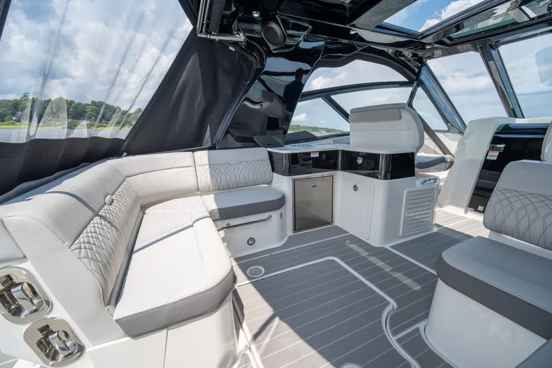 Slide: The Image of The image shows the cockpit of a 2026 Sea Ray Sundancer 370 Outboard with luxurious seating and modern amenities. - 12