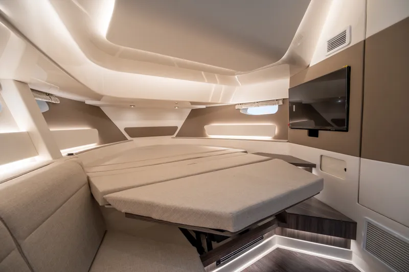 Slide: The Image of Interior of a modern yacht with sleek seating, a table, and a flat-screen TV. - 32