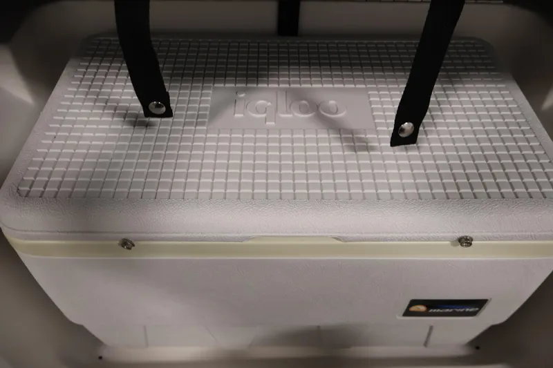 Slide: The Image of White Igloo cooler secured with black straps inside a 2015 Starcraft Star Step 220 I/O boat. - 16