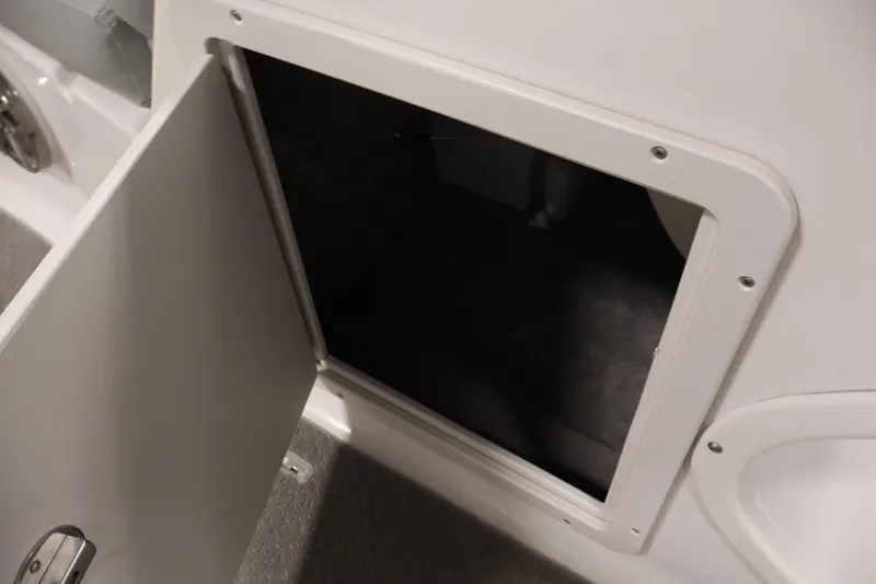 Slide: The Image of Open storage compartment on 2015 Starcraft Star Step 220 I/O boat. - 18