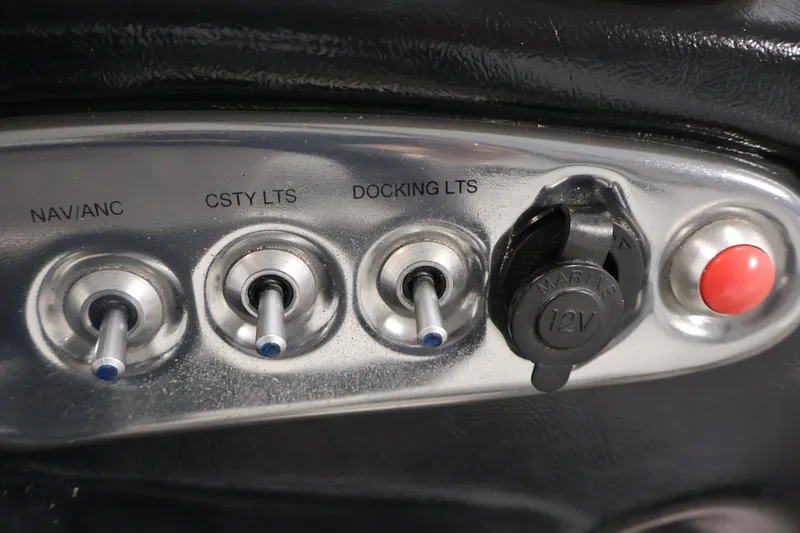 Slide: The Image of Control panel of a 2015 Starcraft Star Step 220 I/O boat with switches and 12V outlet. - 23