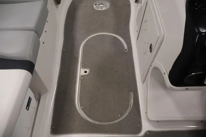 Slide: The Image of Interior view of a 2015 Starcraft Star Step 220 I/O boat, featuring seating and carpeted flooring. - 30