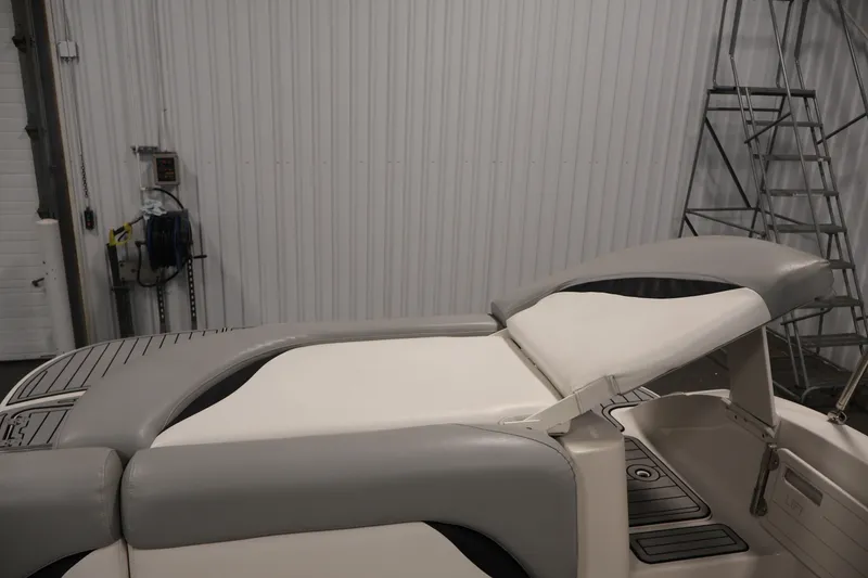Slide: The Image of 2015 Starcraft Star Step 220 I/O boat interior with gray and white seating in a garage. - 35