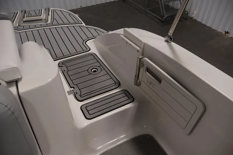Slide: The Image of 2015 Starcraft Star Step 220 I/O boat interior with gray deck and storage compartment. - 37