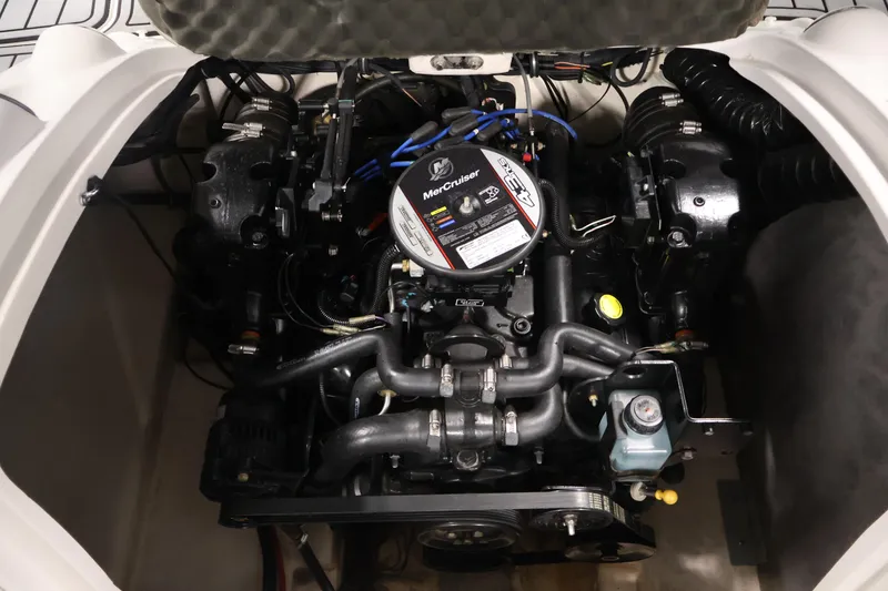 Slide: The Image of Engine compartment of a 2015 Starcraft Star Step 220 I/O boat, featuring a MerCruiser engine. - 38