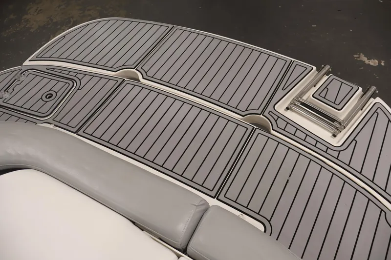 Slide: The Image of 2015 Starcraft Star Step 220 I/O boat deck with gray non-slip surface and foldable ladder. - 40
