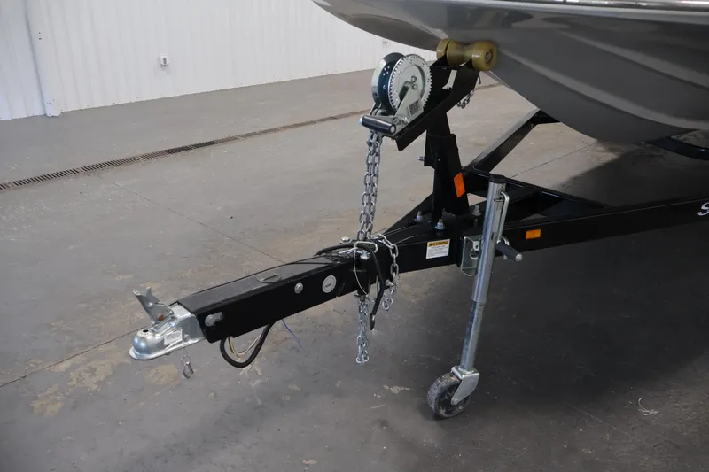 Slide: The Image of 2015 Starcraft Star Step 220 I/O boat trailer hitch and winch in a garage. - 46