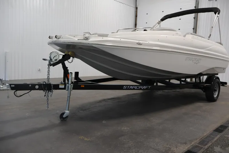 Slide: The Image of 2015 Starcraft Star Step 220 I/O boat on trailer in indoor setting. - 47