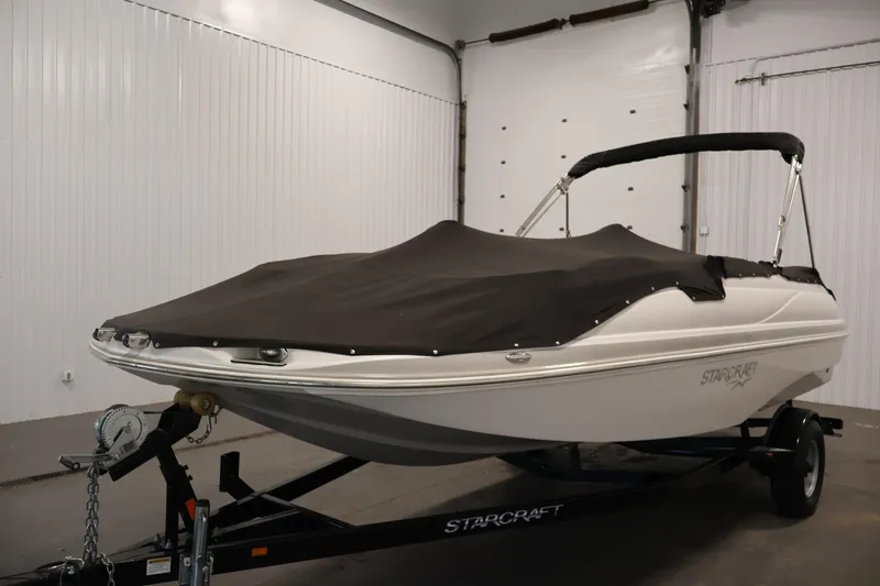 Slide: The Image of 2015 Starcraft Star Step 220 I/O boat with cover on trailer in garage. - 49