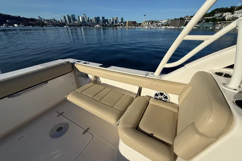 Slide: The Image of 2016 Pursuit DC 265 Dual Console boat with city skyline in the background. - 12