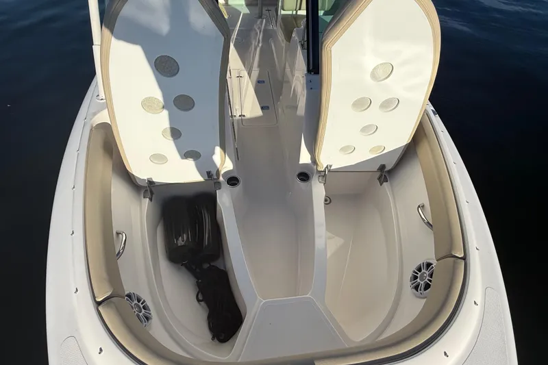 Slide: The Image of 2016 Pursuit DC 265 Dual Console boat interior with open storage compartments. - 20