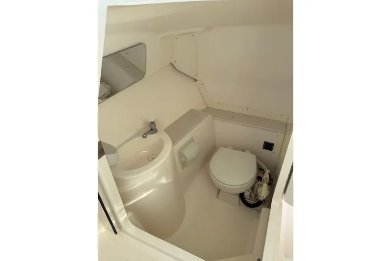 Slide: The Image of 2016 Pursuit DC 265 Dual Console boat interior bathroom with sink and toilet. - 25