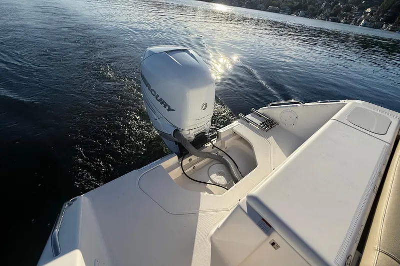 Slide: The Image of 2016 Pursuit DC 265 Dual Console boat with Mercury outboard engine on calm water. - 27
