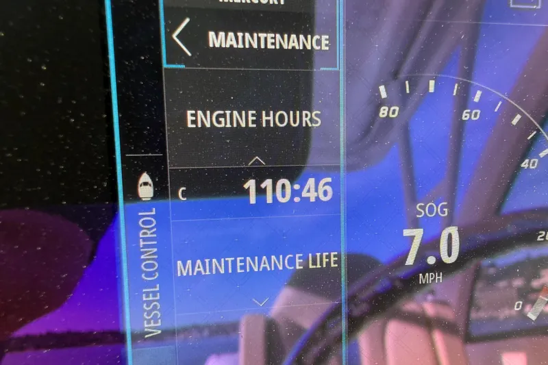 Slide: The Image of Display screen showing engine hours and speed on a 2016 Pursuit DC 265 Dual Console. - 28