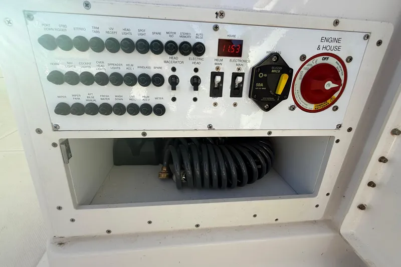 Slide: The Image of Control panel of a 2016 Pursuit DC 265 Dual Console boat with switches and wiring. - 29