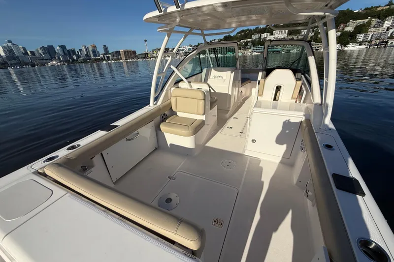 Slide: The Image of 2016 Pursuit DC 265 Dual Console boat interior with city skyline in background. - 4