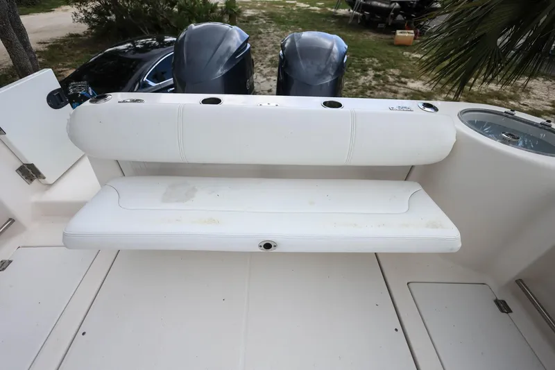Slide: The Image of 2018 Robalo R305 Walkaround boat with white seating and dual outboard motors. - 10