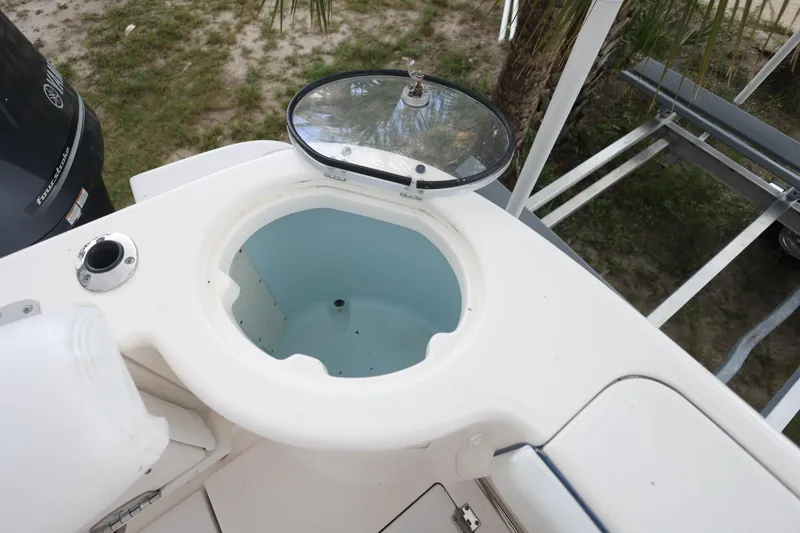 Slide: The Image of 2018 Robalo R305 Walkaround boat livewell with open lid, showcasing interior design. - 12