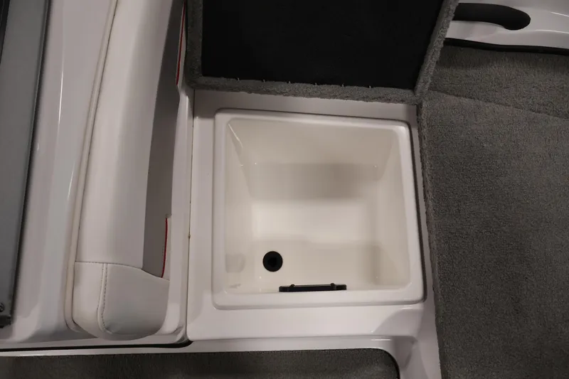 Slide: The Image of 2019 Nitro Z19 Sport boat storage compartment with gray carpet and white interior. - 17