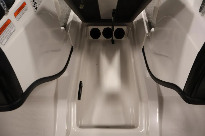 Slide: The Image of 2019 Nitro Z19 Sport boat interior storage compartment with open lids and cup holders. - 19
