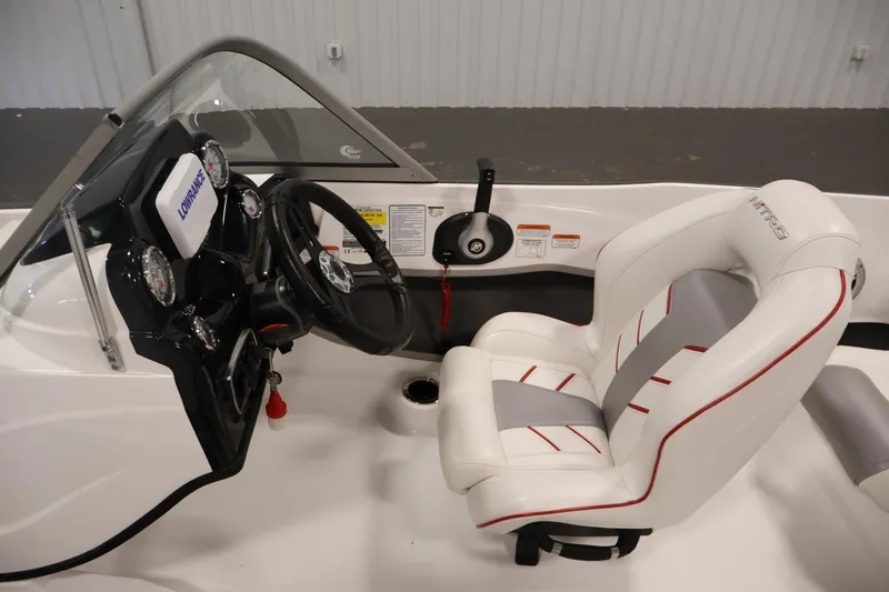 Slide: The Image of 2019 Nitro Z19 Sport boat interior with steering wheel and white cushioned seat. - 20